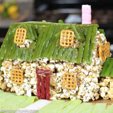 The Family Guy house made of caramel popcorn and decorated with pretzels, red and green licorice, graham crackers.