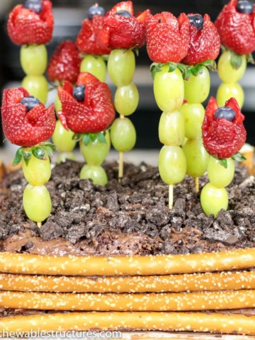 Mother's Day Dessert Idea: chocolate cake topped with strawberry roses and decorated to look like a garden.