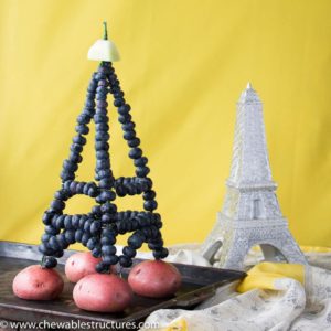 Eiffel tower made of wires strung through fresh blueberries and topped with a honeydew deck.