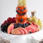 Snowman made of Fuyu persimmons, blueberries, and green grapes.