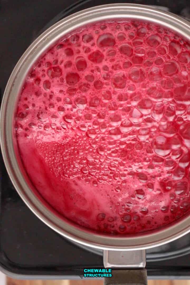 bright red candy apple mixture  cooking in a pot
